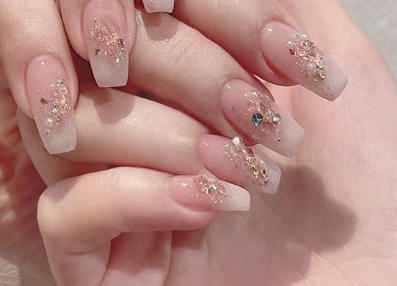 99+ mẫu nail đính đá vừa XINH vừa SANG cho nàng tự tin ra ngoài 13 Bàn tay với móng tay dài được trang trí lấp lánh và ánh kim, tạo kiểu nghệ thuật và tinh tế.