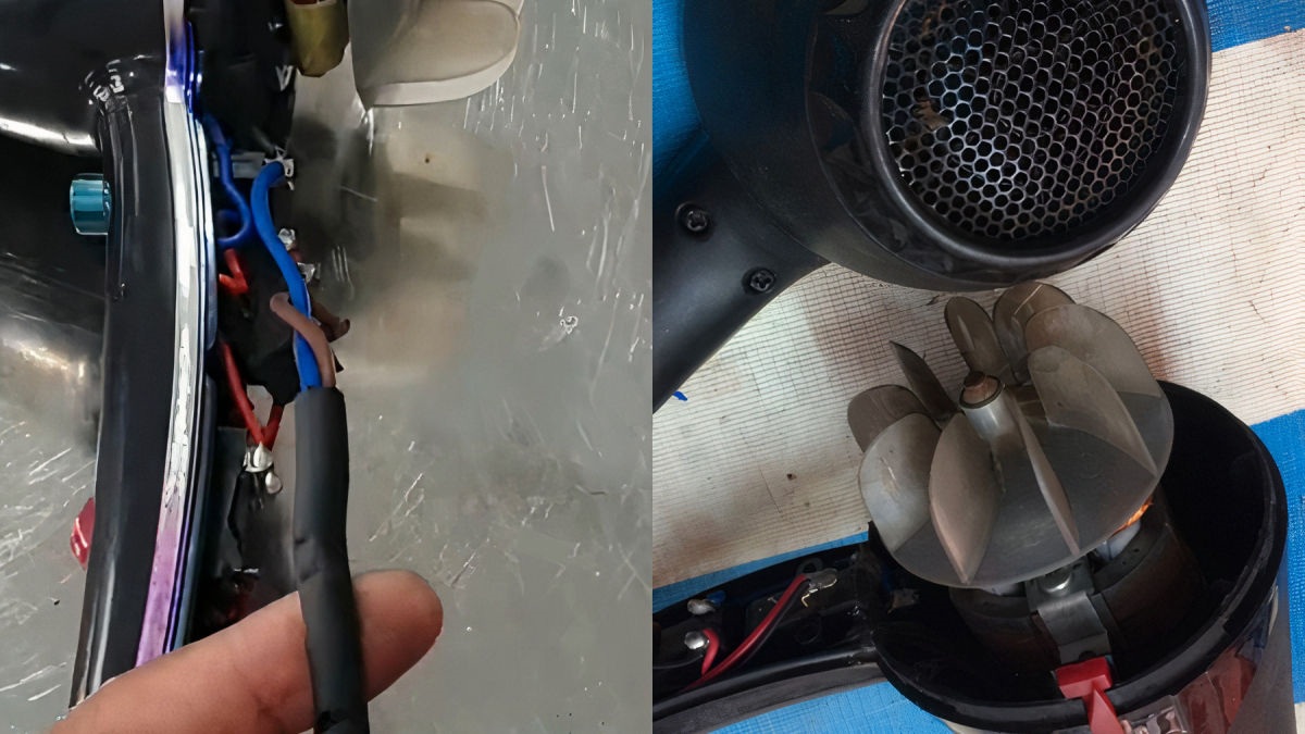 Hình ảnh một người đang lắp ráp thiết bị điện với dây điện và bộ phận bên trong được mở ra.