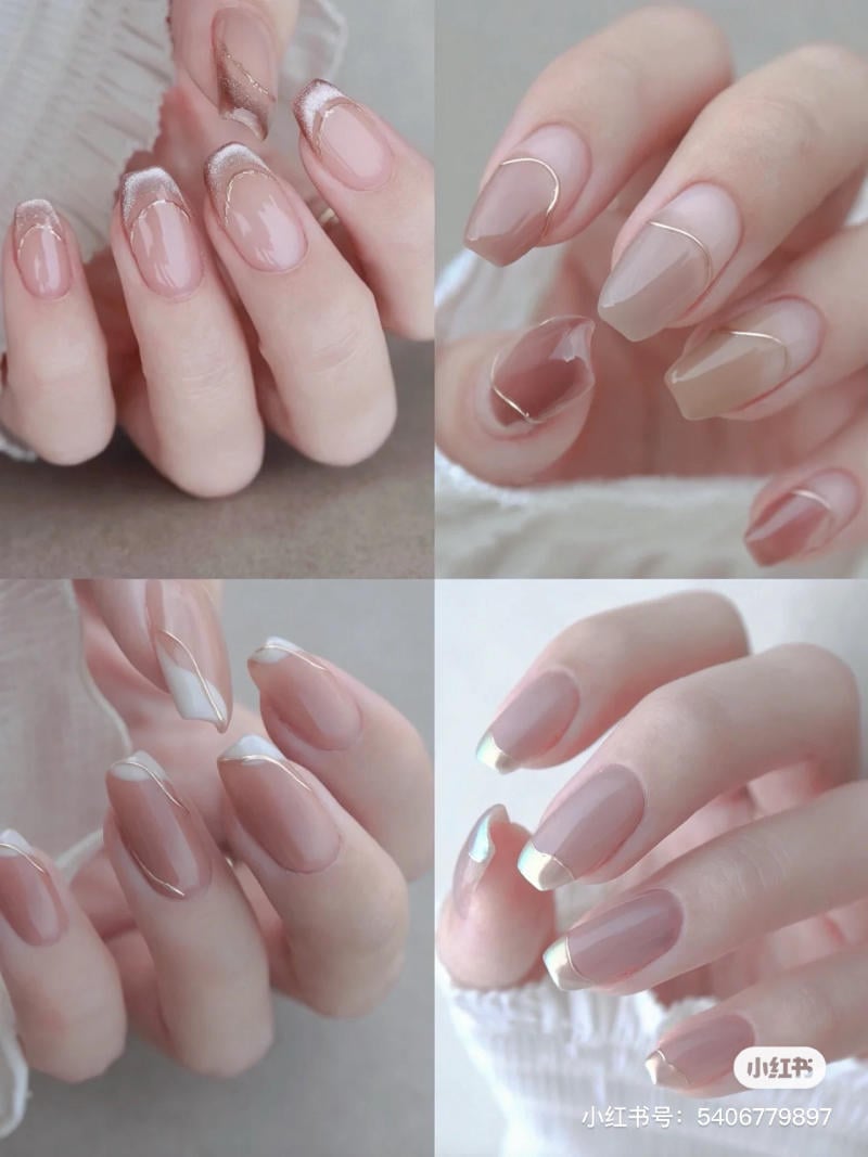 mau-nail-don-gian-cardina__98__bd322ea0b4ac42d49d4862a6a3987d72 Bàn tay với móng tay dài, được sơn màu hồng nhạt và trang trí bằng các họa tiết tinh tế khác nhau.