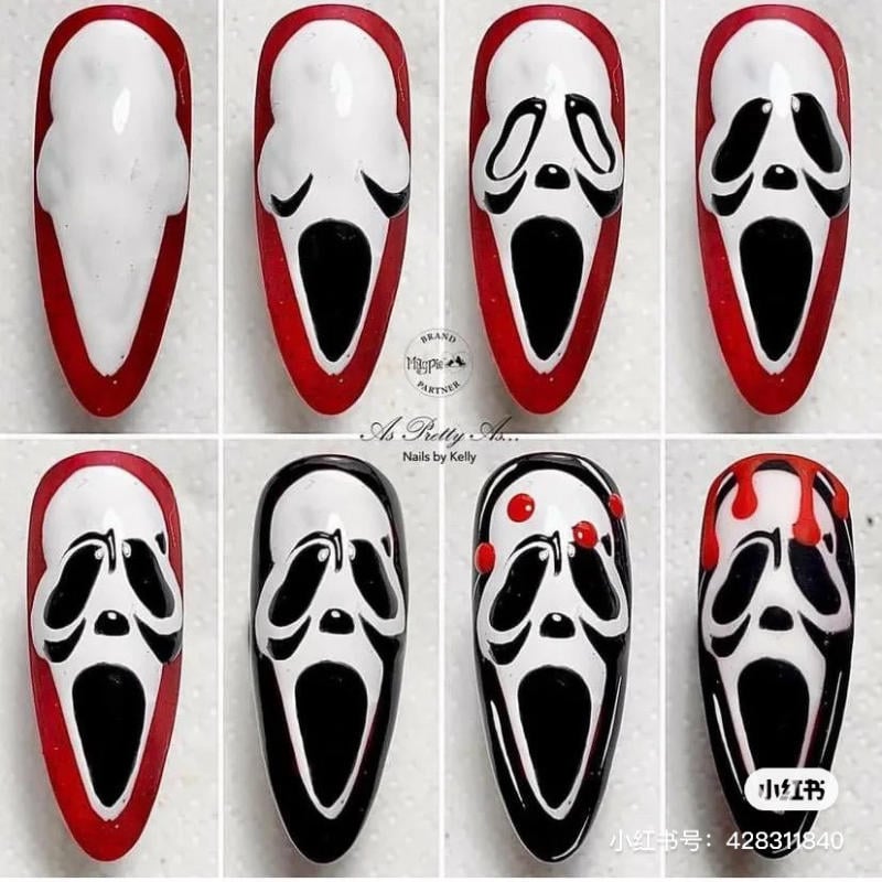 mau-nail-halloween-2023__7__80aab5b46a954efcb5b3af4b1279b044 Nghệ thuật móng tay với thiết kế khuôn mặt kinh dị, màu đen trắng và đỏ, có chi tiết giọt sơn.
