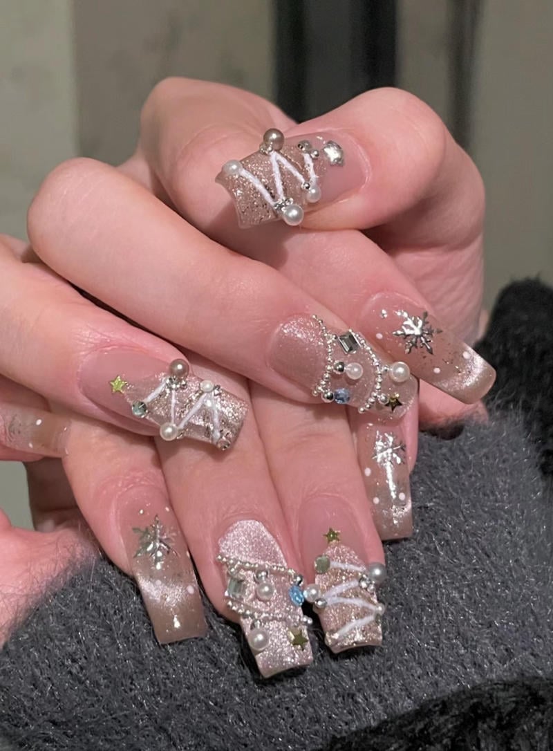 mau-nail-nhu-dep__61__207c5646dc1e4c9ba9ca02c5c3c6f71e Bàn tay với móng tay dài, được trang trí với kim cương giả, ngọc trai và các họa tiết lấp lánh.