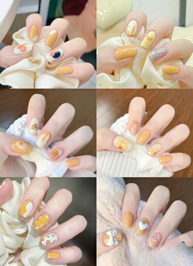 Bộ ảnh móng tay với nền màu vàng, trang trí đa dạng họa tiết hình trái tim và hoa văn sáng tạo.
