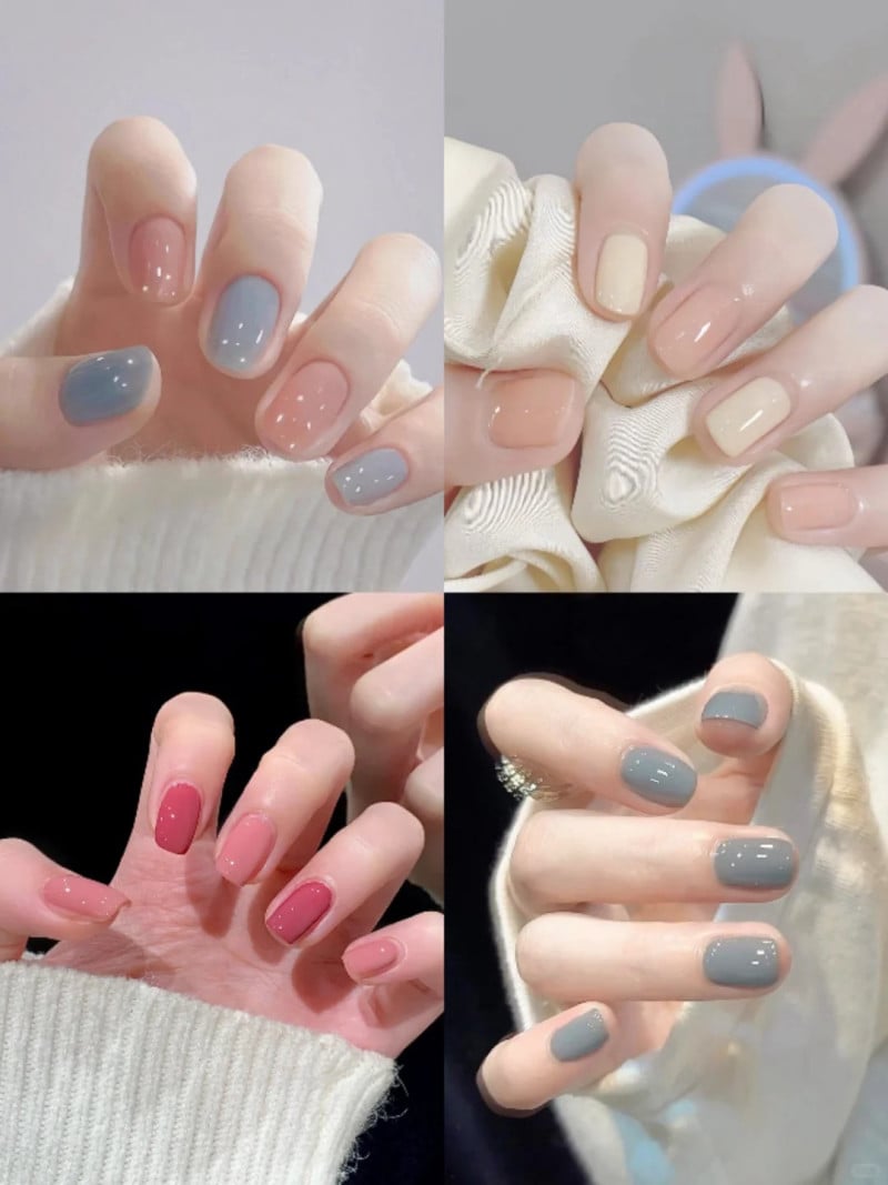 Các bàn tay với móng tay được sơn nhiều màu khác nhau như xám, hồng và be, tạo kiểu thời trang.