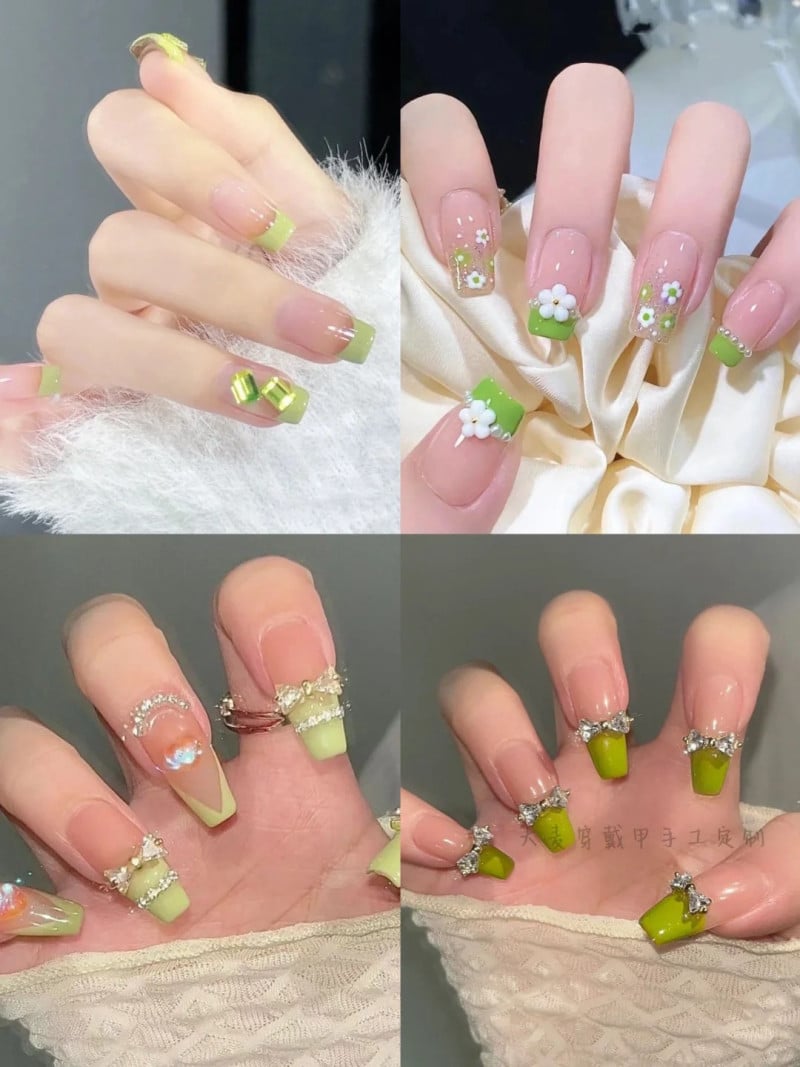 Bộ móng tay với họa tiết và màu xanh lá, trang trí hoa và đá, tạo kiểu sáng tạo và tinh tế.