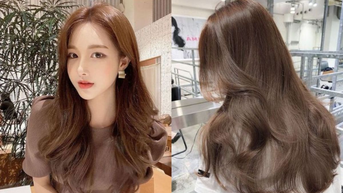 Người với mái tóc dài nâu xoăn nhẹ, ngồi trong không gian nội thất hiện đại, bên cạnh là cây xanh.