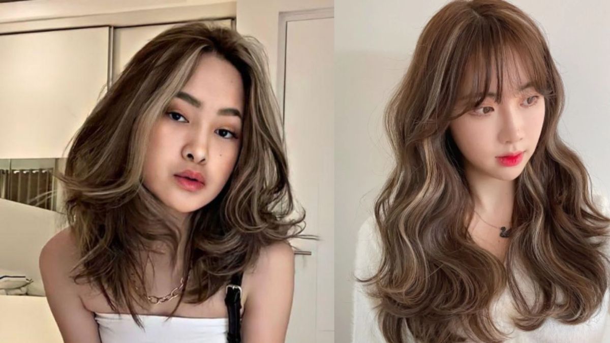 Hai người với kiểu tóc dài khác nhau, tóc nhuộm màu nâu sáng, đứng trong phòng có ánh sáng tự nhiên.