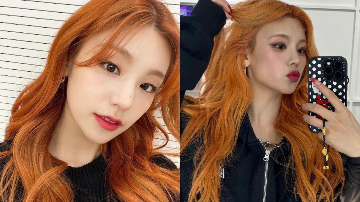 H&igrave;nh ảnh hai người chụp ảnh tự sướng, t&oacute;c m&agrave;u cam, trang điểm nhẹ, nền tường trắng sọc ngang.