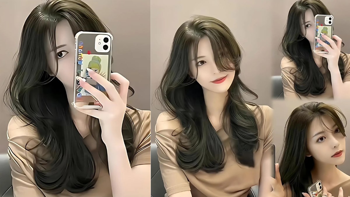 nau-kiwi-13 Người chụp ảnh selfie với kiểu tóc dài uốn lọn, mặc áo màu nâu, sử dụng điện thoại có ốp lưng hoạt hình.