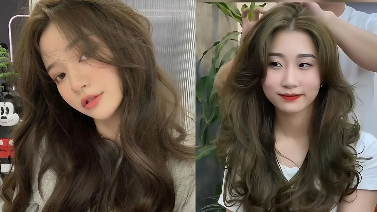 nau-kiwi-4 Hai người với tóc dài gợn sóng, một người đang được tạo kiểu tóc trong không gian nội thất có cây xanh.