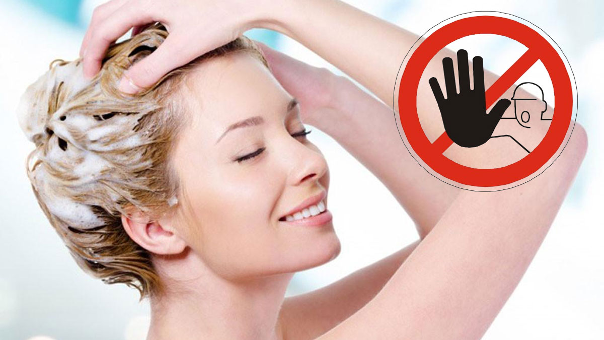 Người đang gội đầu với bọt xà phòng, bên cạnh là biểu tượng cảnh báo không được làm gì đó.