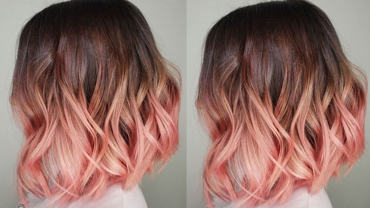 Kiểu tóc ombre nâu đen và hồng, dài ngang vai, xoăn nhẹ, được chụp từ phía sau.