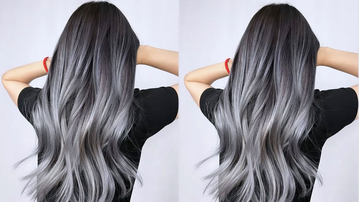 Người mặc áo đen với mái tóc dài nhuộm màu xám khói, đứng quay lưng lại, tóc thả tự nhiên.