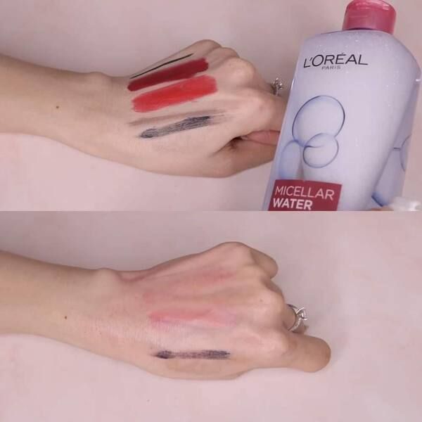 nuoc_tay_trang_l_oreal_cho_da_kho_voi_kha_nang_lam_sach__cap_am_cho_da_a1f8a40d8b604328b3088e362c32e798_grande Tay cầm chai nước tẩy trang, thử nghiệm làm sạch vết son đỏ và kẻ mắt đen.