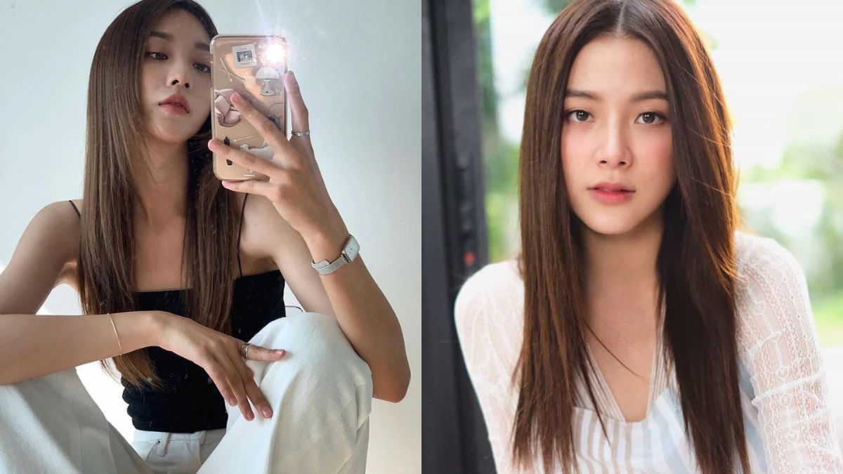 Hai người phụ nữ với mái tóc dài, một người đang chụp ảnh selfie, người kia nhìn thẳng vào máy ảnh.