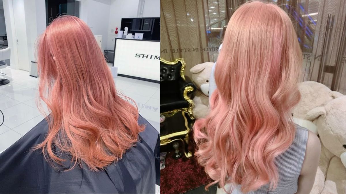 Tóc nhuộm màu hồng pastel, dài và uốn lượn sóng, chụp từ phía sau trong không gian nội thất hiện đại.