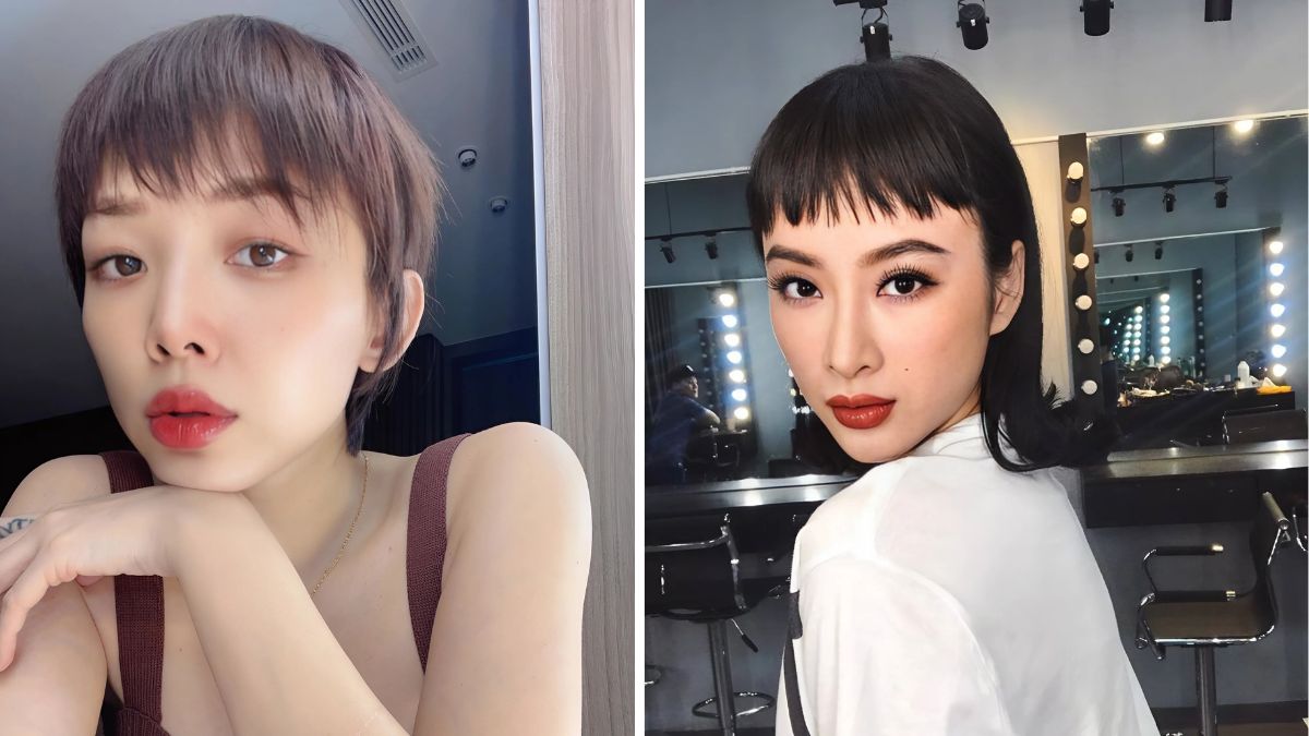 toc-mai-ngo-7 Hai người phụ nữ với kiểu tóc ngắn và trang điểm đậm, đứng trước gương với đèn sáng phía sau.