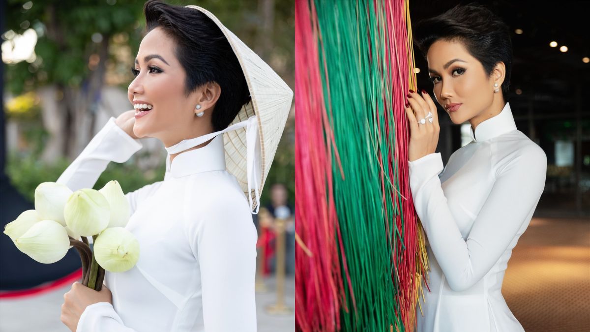 toc-ngan-mac-ao-dai-12 Người phụ nữ mặc áo dài trắng, cầm hoa sen, đội nón lá và đứng cạnh dây màu sắc.