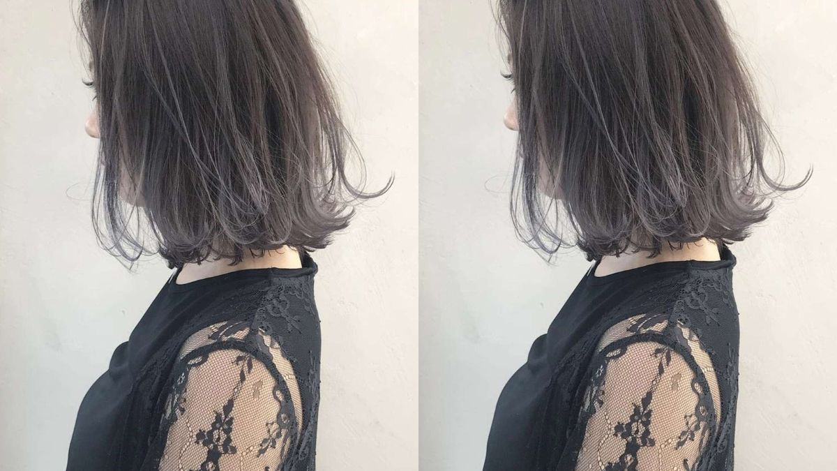 Người mặc áo ren đen, tóc ngắn màu xám, chụp từ phía bên cạnh.